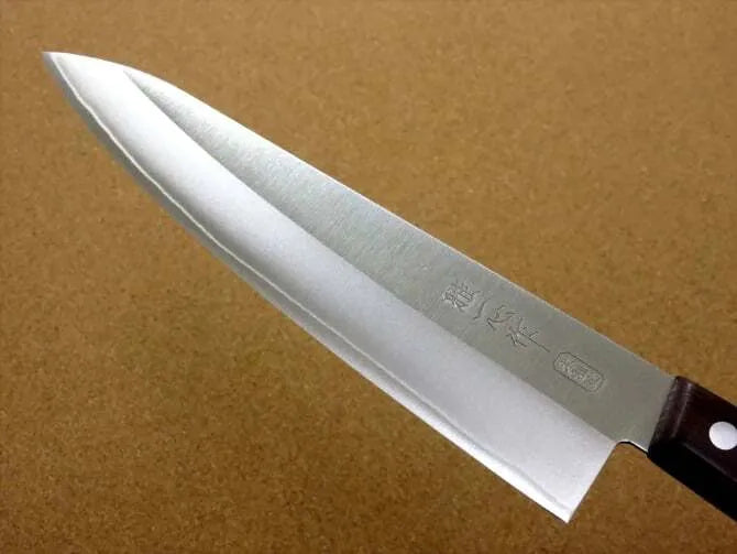 A close-up of a Kanetsugu Miyabi Issin Chef Knife with a focus on the blade's sharp edge.