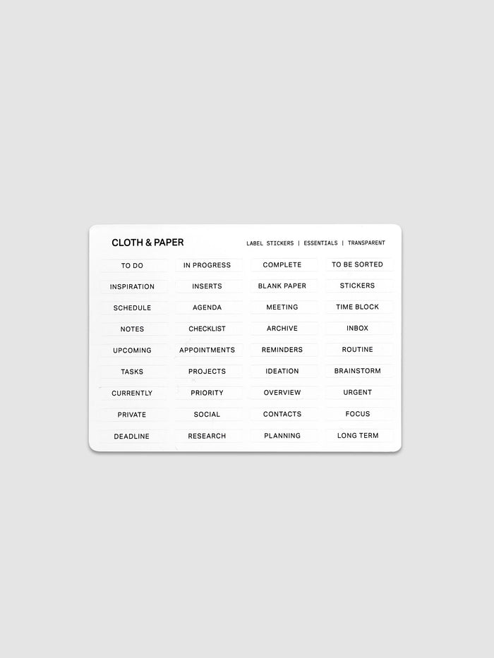 One sheet of transparent label stickers with black printed text on the theme of essentials.