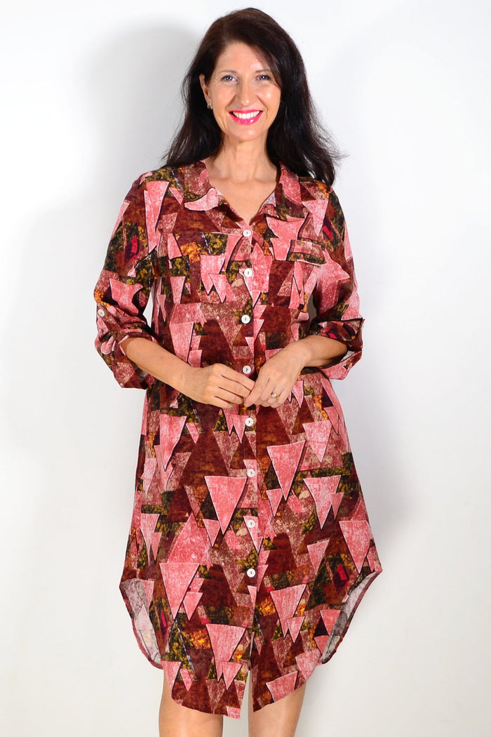 Pink printed ladies long tunic shirt from Wishstone with a relaxed fit and stylish design, shown on a hanger.