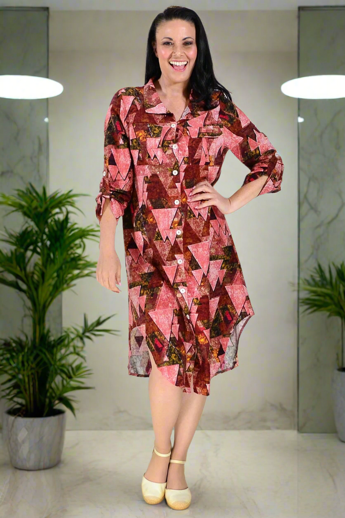 Pink printed ladies long tunic shirt by Wishstone, featuring a relaxed fit and stylish design, displayed on a hanger.