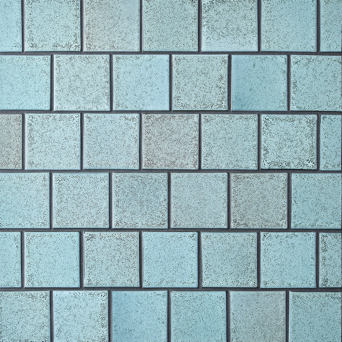 Caption: Classic Field 3x3 in LM1 Chalk-Gunmetal. Prism Charcoal grout by Custom Building Products.