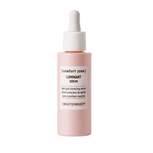 A pink dropper bottle of Luminant Serum | [ comfort zone ], a skincare product designed for dark spot correction using 3-Bright Technology.