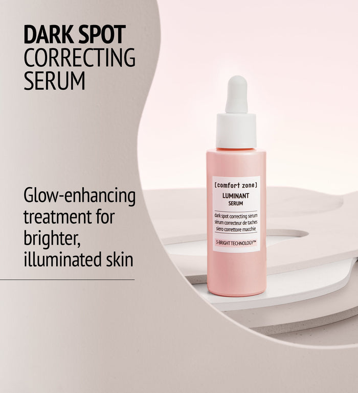 Bottle of Luminant Serum | [ comfort zone ] in soft pink packaging with dropper, displayed as a dark spot correcting skincare product for brighter, illuminated skin.