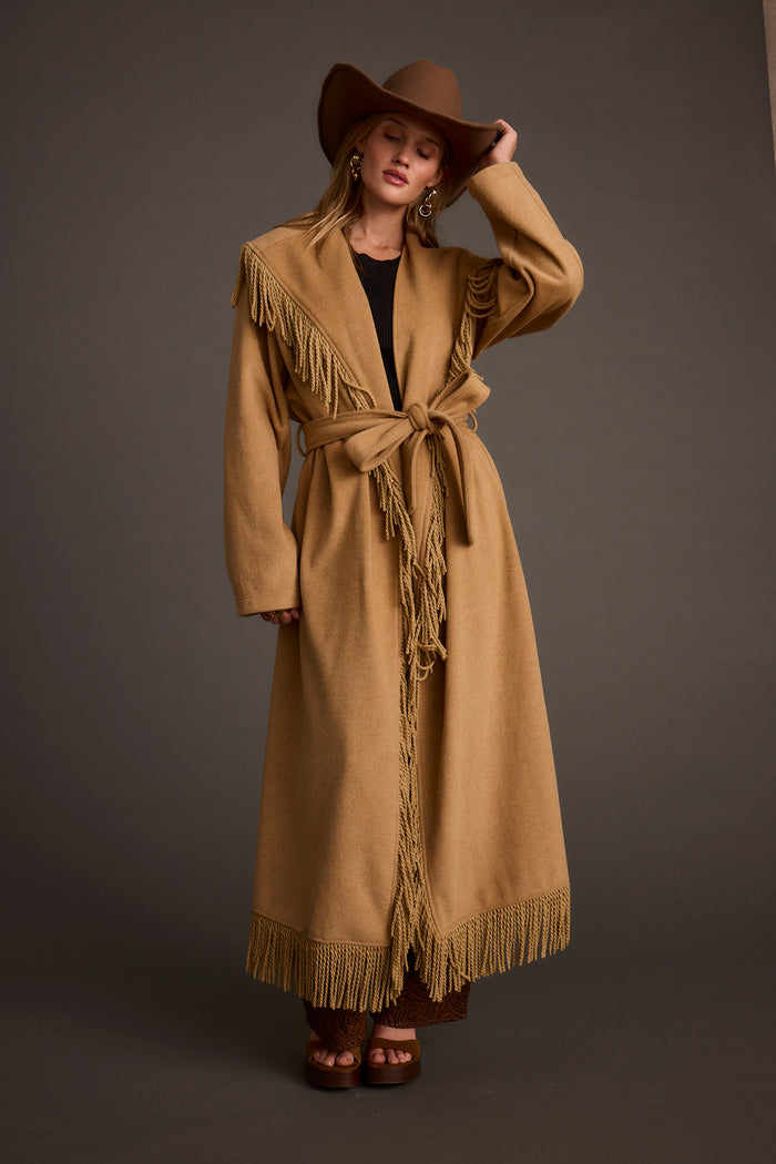 Back view of the camel fringe jacket showing the silhouette and fit.