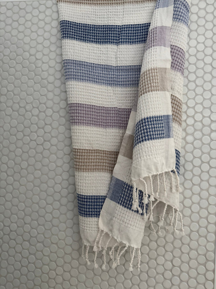 Multi Stripe Waffle Towel hanging on tiled bath wall - ANNIE.G