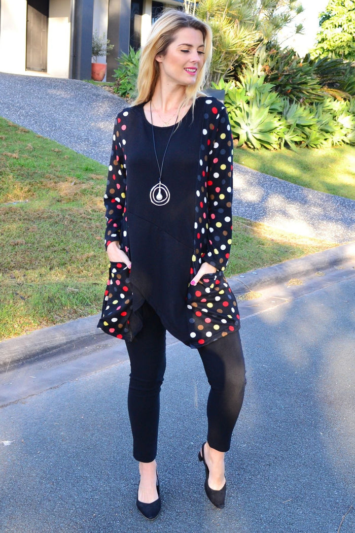 Peony multicolour pockets and dots winter tunic top with long sleeves and a relaxed fit, displayed on a hanger.