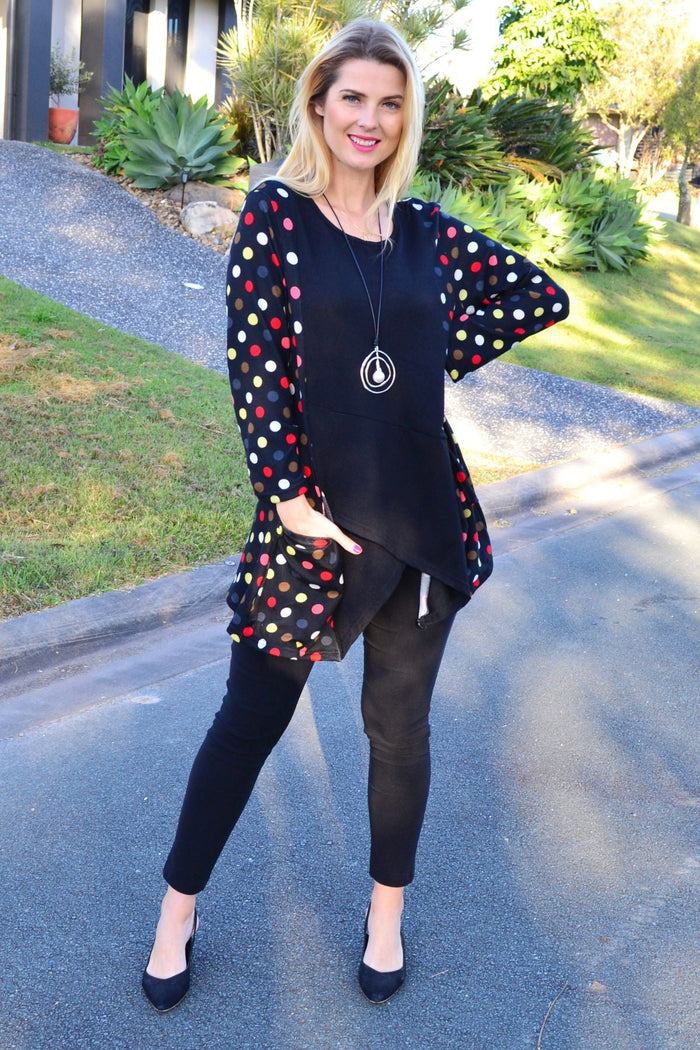 Peony multicolour pockets and dots winter tunic top with long sleeves and a relaxed fit, displayed on a hanger.