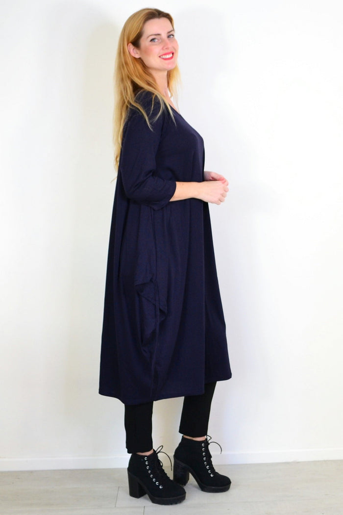 Navy blue oversized tunic dress by Lilia Whispers, relaxed fit with long sleeves, displayed on a hanger.
