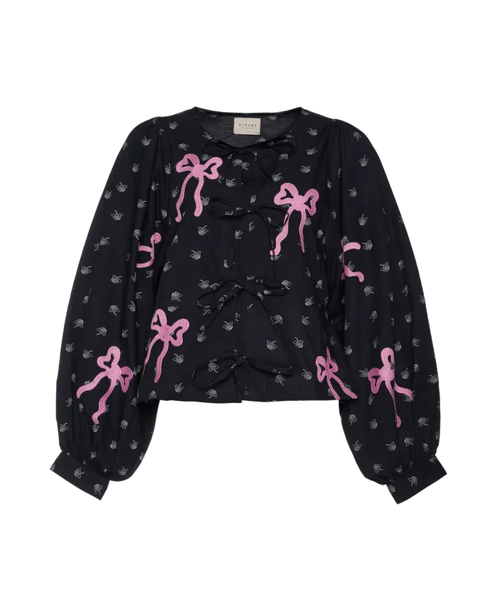 Black blouse with pink bow patterns.