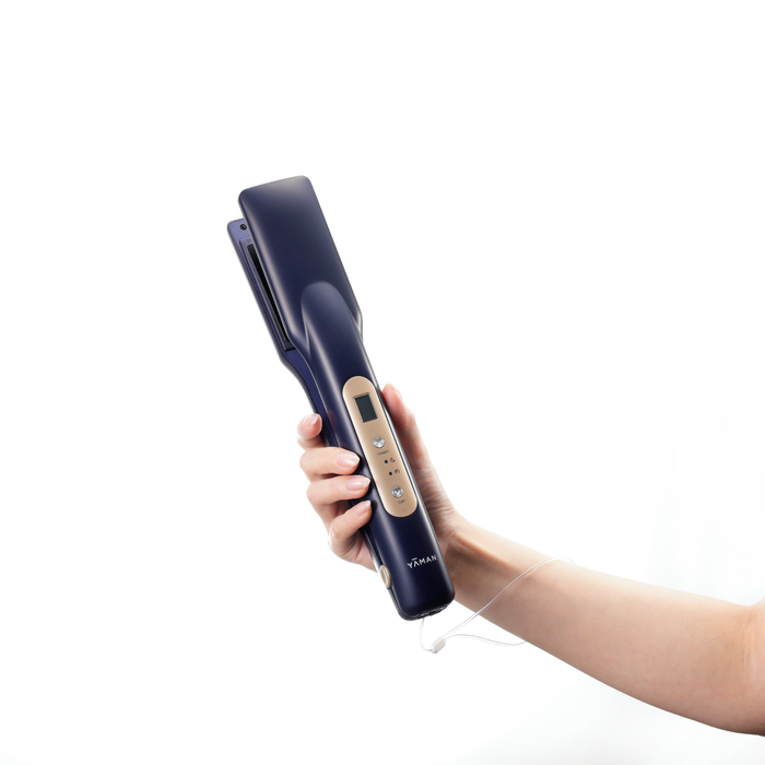 Hand holding a blue hair straightener on a white background