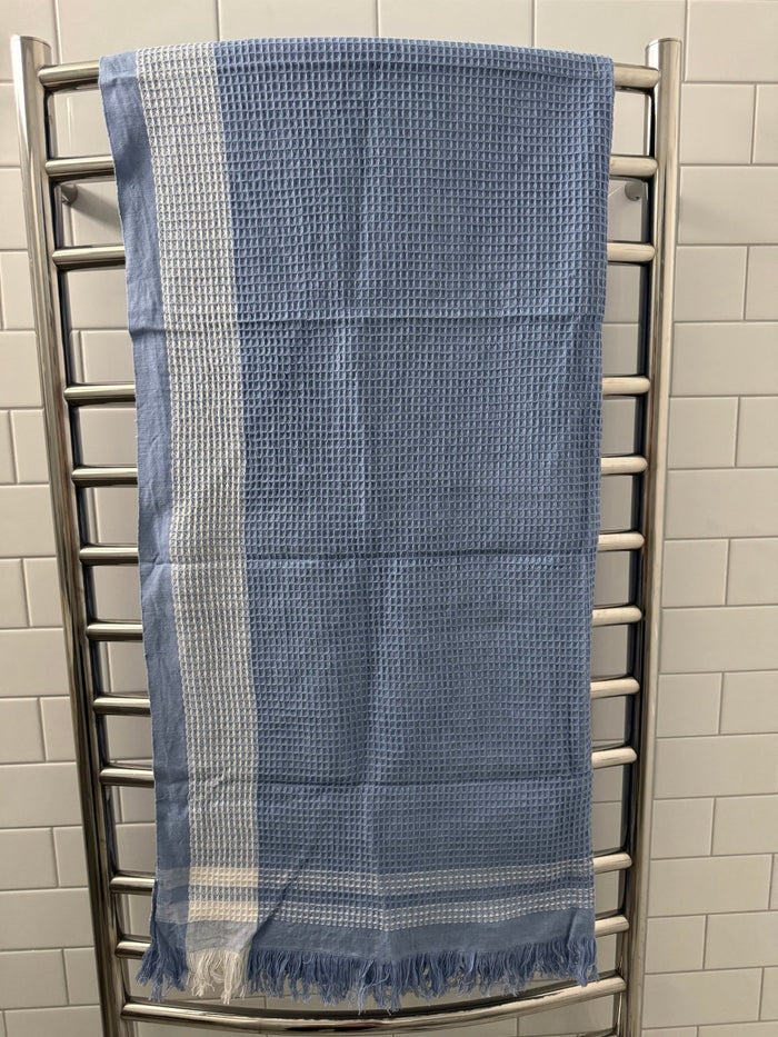 Periwinkle Border Waffle Towel hanging on a heated towel rail - ANNIE.G