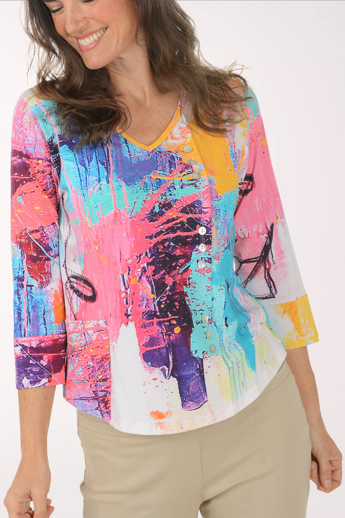 Woman wearing a multicolored 3/4 sleeve top.