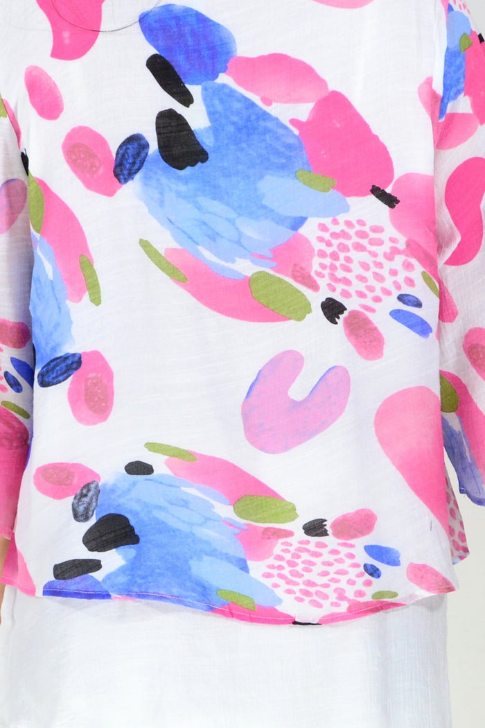 Pink and blue paint splash tunic top by Wishstone, featuring vibrant abstract design and lightweight fabric.