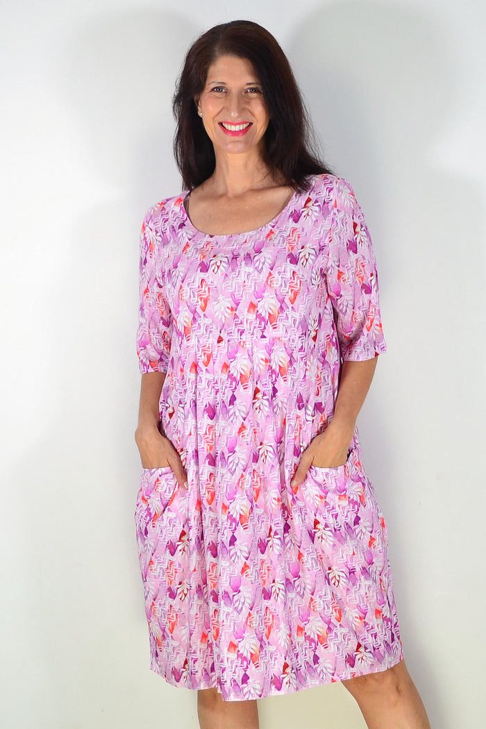 Pink and purple printed summer tunic dress by Ruby Rain featuring a flowy, lightweight fabric and vibrant floral design.