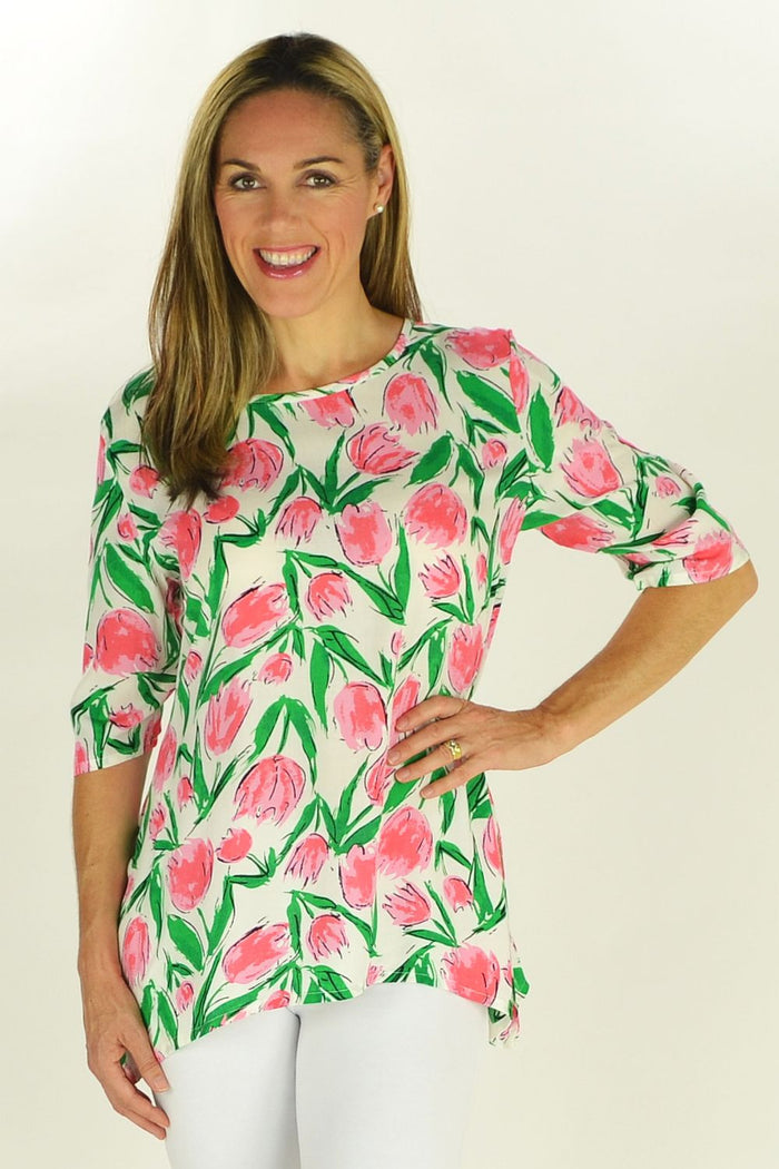 Pink Tulips Sun Rose tunic displayed on a hanger with floral pattern and lightweight fabric, stylish and comfortable for casual wear.