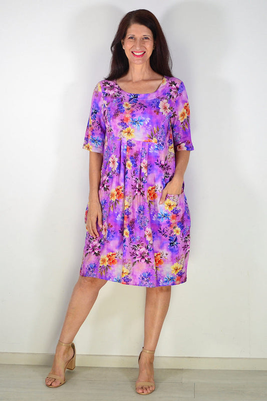 Purple floral print summer tunic dress by Ruby Rain, featuring a flowing fabric and vibrant floral pattern.