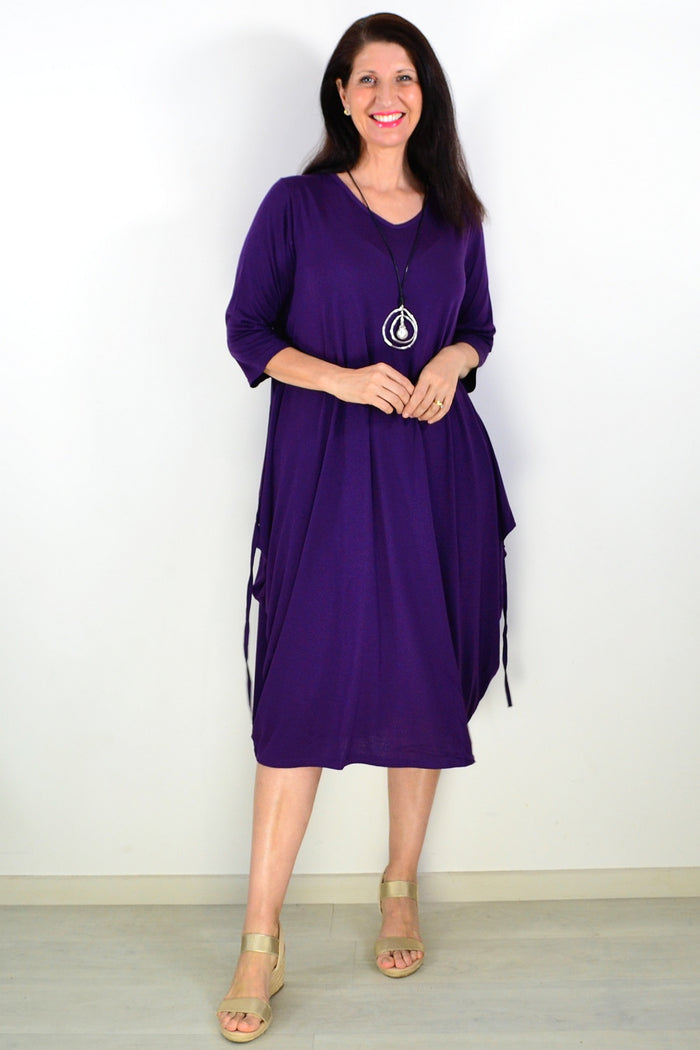 Purple relaxed oversized tunic dress by Lilia Whispers, featuring a loose fit and casual style, shown on a hanger.