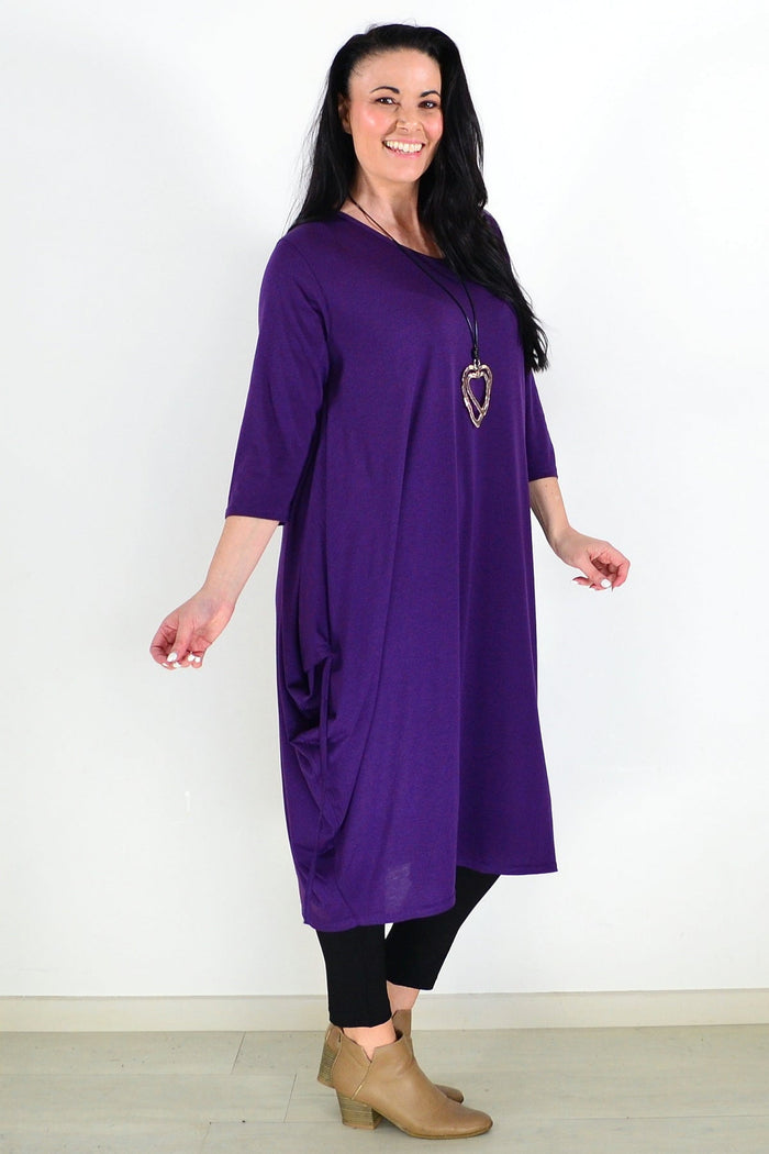 Purple Lilia Whispers oversized tunic dress with relaxed fit, flowing fabric, and long sleeves, displayed on a hanger.