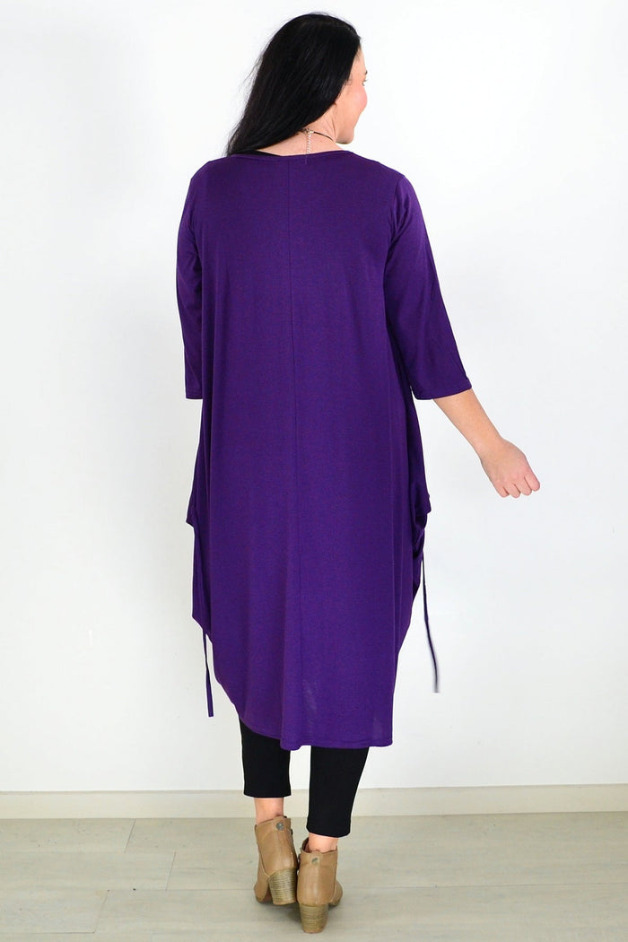 Purple relaxed oversized tunic dress by Lilia Whispers, flowing fabric with a loose fit, displayed on a hanger.
