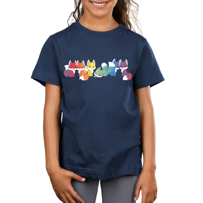 Premium Cotton T-shirt_TeeTurtle navy blue Rainbow Foxes features an illustration of seven cartoon foxes in a line, each in a different color: red, orange, yellow, green, blue, indigo, and purple against a dark background.