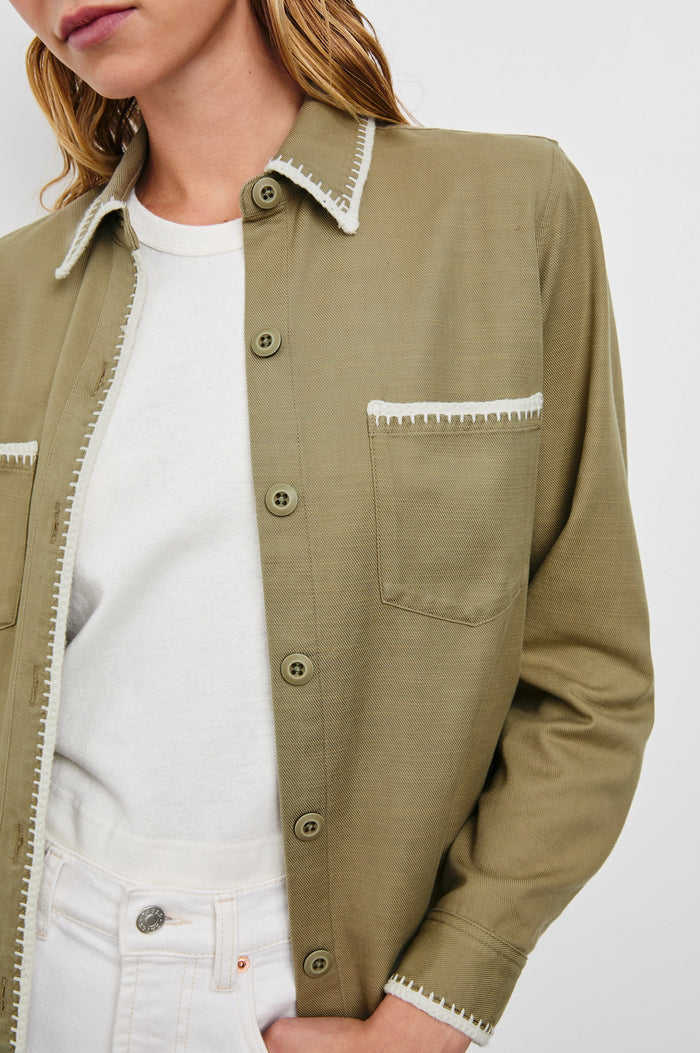 Reigh Jacket with Two Chest Patch Pockets and Button Closure in Pale Olive Colorway with White Trim - Front View Featured on Model