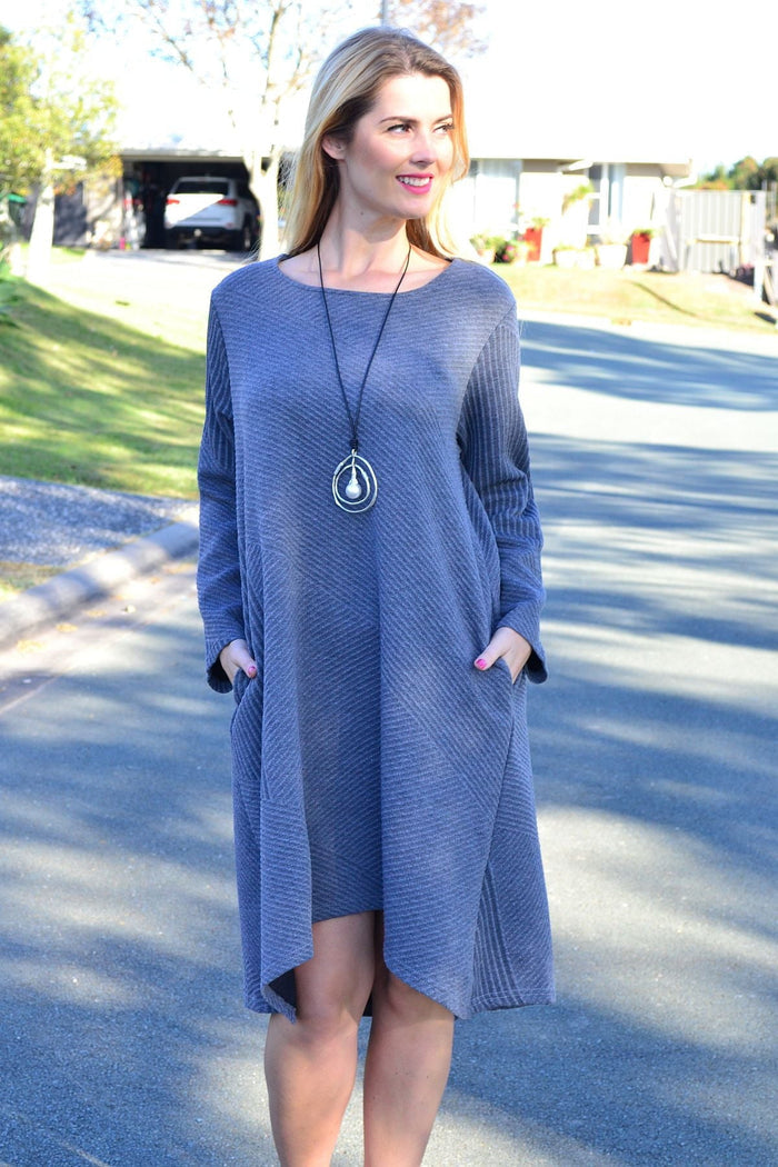 Relaxed grey textured Peony tunic dress with long sleeves and a loose fit, displayed hanging against a neutral background.