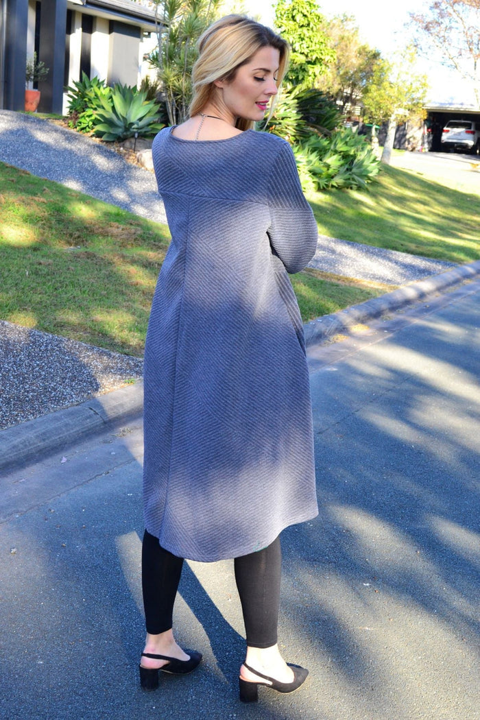 Relaxed grey textured Peony tunic dress displayed on a hanger, showcasing its soft fabric and loose fit style.