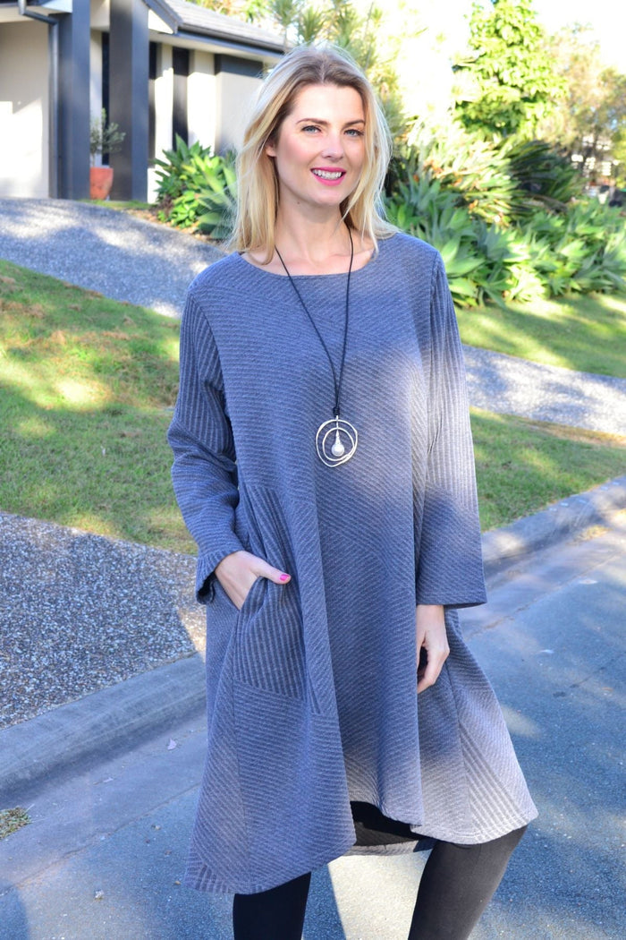 Relaxed grey textured Peony tunic dress with a loose fit, long sleeves, and subtle fabric pattern, styled for casual wear.