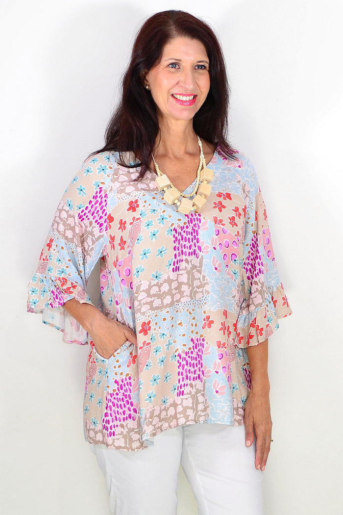 Wishstone relaxed soft floral tunic top with a flowy fit and floral pattern, displayed on a mannequin.