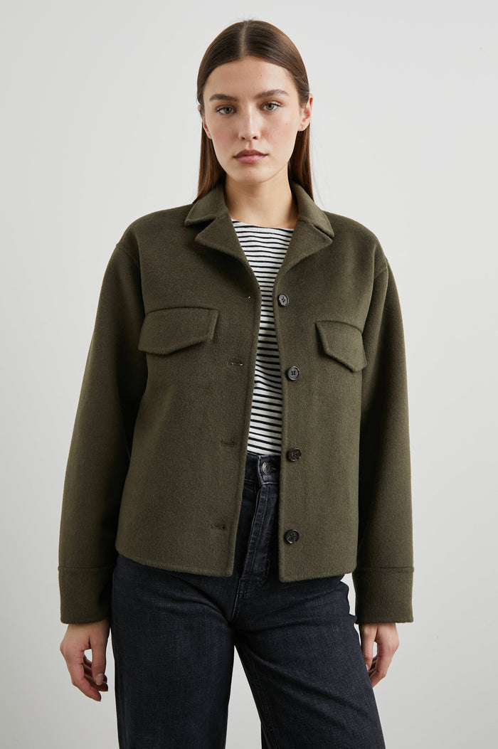 Riley Jacket with Button Closure, a Notched Collar, Two Chest Flap Pockets and Button Cuffs in Olive Colorway - Front View Featured on Model