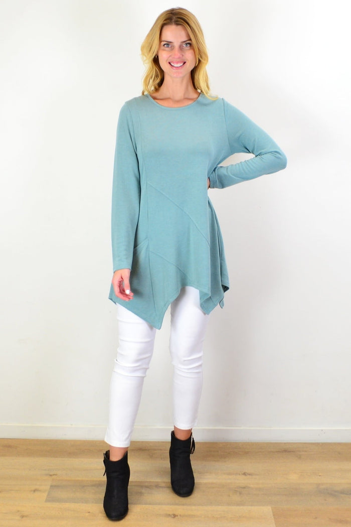 Sage green knit tunic top by Caroline Morgan, featuring a relaxed fit and long sleeves, displayed on a hanger.