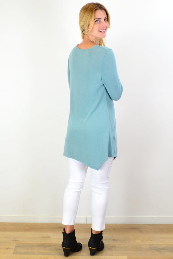 Sage green knit tunic top by Caroline Morgan featuring a relaxed fit and long sleeves, displayed on a plain background.