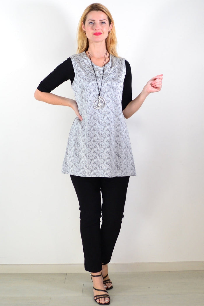 Silver rose sleeveless tunic top by Lilia, featuring a flowy design and sleeveless style, displayed on a hanger against a neutral background.