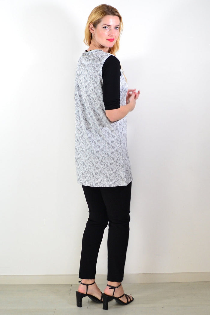 Silver rose sleeveless tunic top by Lilia, displayed on a hanger with a flowy fabric and simple neckline.
