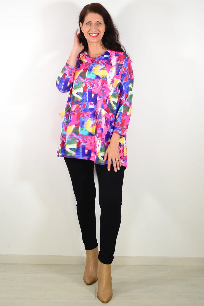 Wishstone Splash Of Colour tunic top displayed on a hanger, featuring vibrant fabric and stylish design, perfect for casual wear.