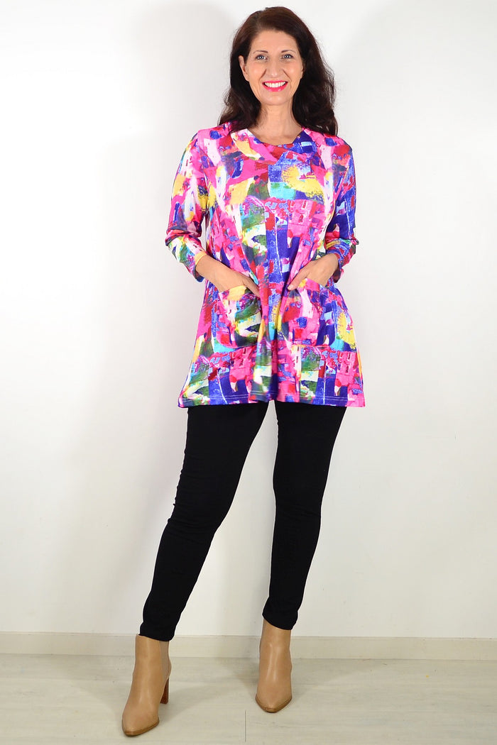Wishstone Splash Of Colour tunic top shown on a hanger, featuring vibrant, abstract print and lightweight fabric for casual wear.