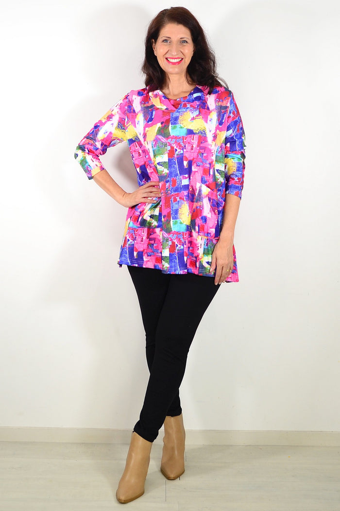 Wishstone Splash Of Colour tunic top with vibrant patterns and relaxed fit, displayed on a hanger.