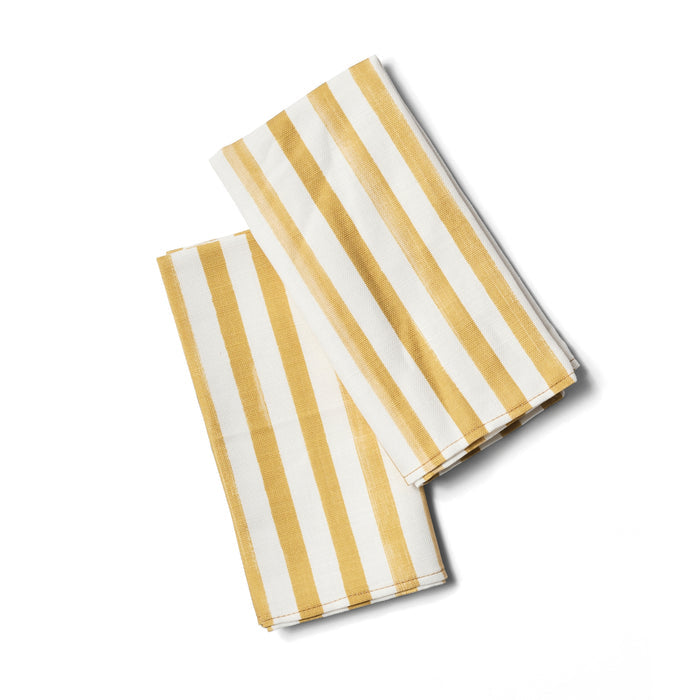 Two yellow and white striped napkins folded.