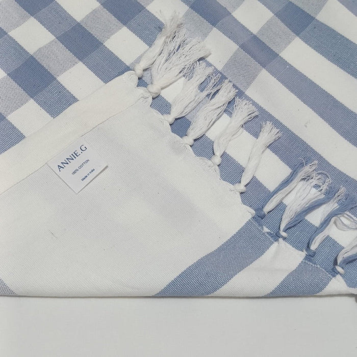 ANNIEG Brand label on light blue checked tablecloth with hand knotted ends - ANNIE.G
