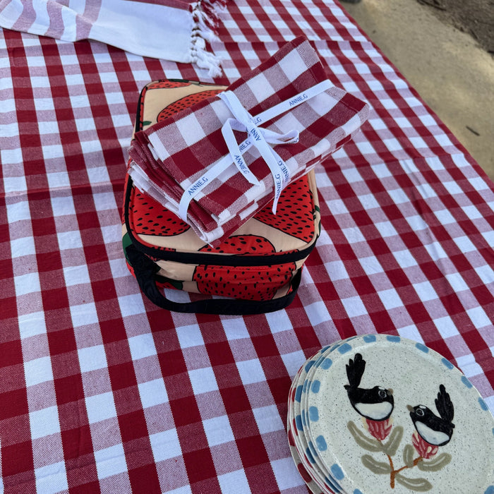 Rectangular red and white gingham cotton tablecloth with plates, wrapped set of red napkins and strawberry lunch box on top - ANNIE.G