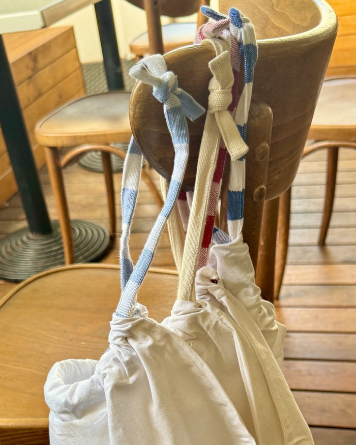 Tablecloth storage bag with with drawstring closure.