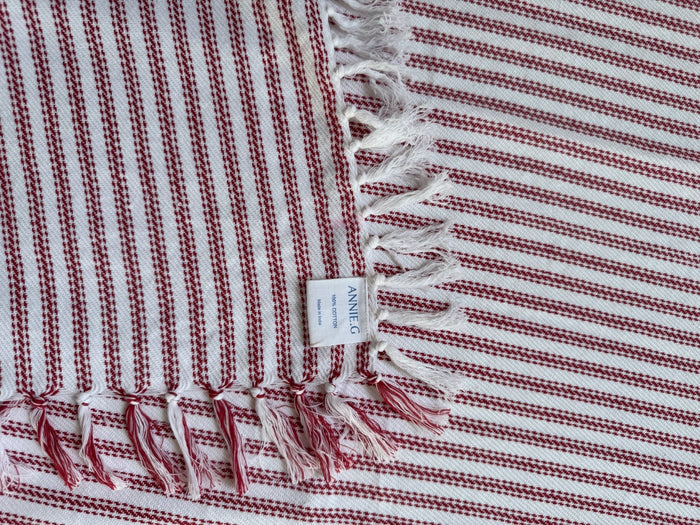tablecloth-square-red-ticking-folded-edge-showing-brand-label-and-hand-knotted-edge