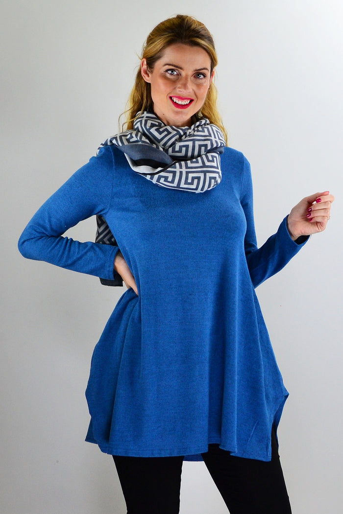 Teal blue knit tunic top from Hourglass, showing a close-up of the soft, textured fabric and relaxed fit.