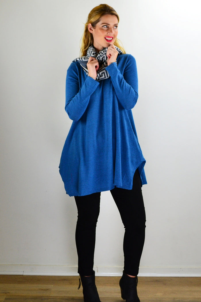 Teal blue knit tunic top from Hourglass, featuring a relaxed fit and textured fabric, displayed on a plain background.