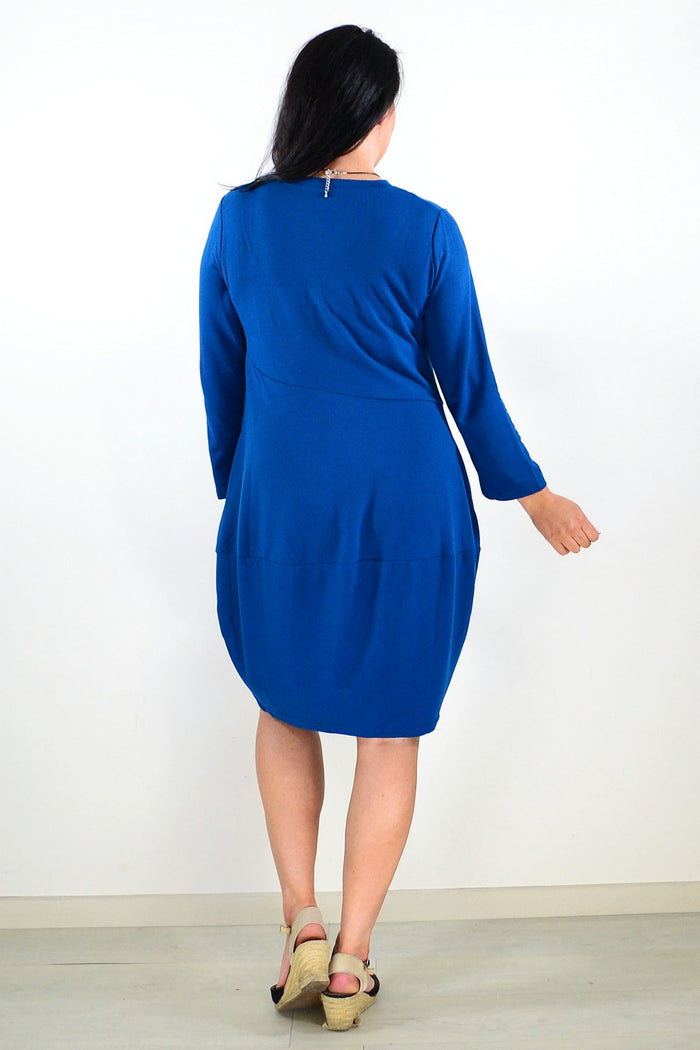 Peony teal cocoon winter pocket tunic dress displayed on a hanger, featuring a relaxed fit and cozy fabric for cold weather.