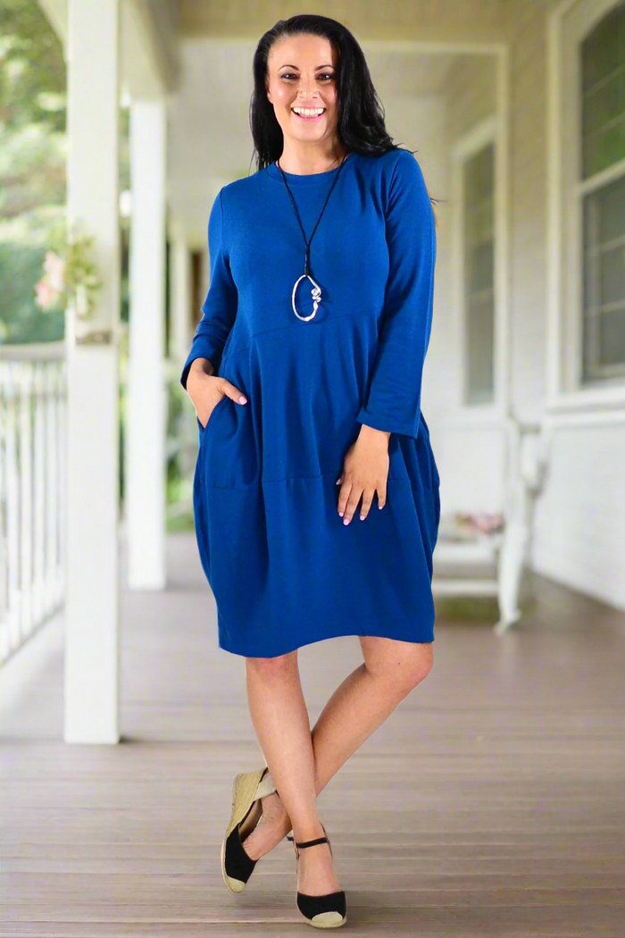 Teal Peony Cocoon Winter Pocket Tunic Dress with cozy fabric and side pockets, displayed on a hanger.
