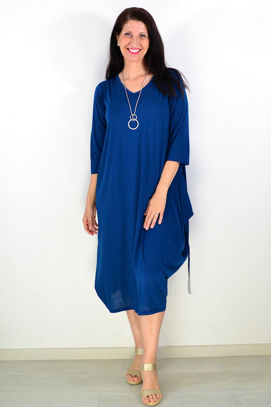 Lilia Whispers teal relaxed oversized tunic dress displayed on a hanger, showcasing its loose fit and soft fabric.