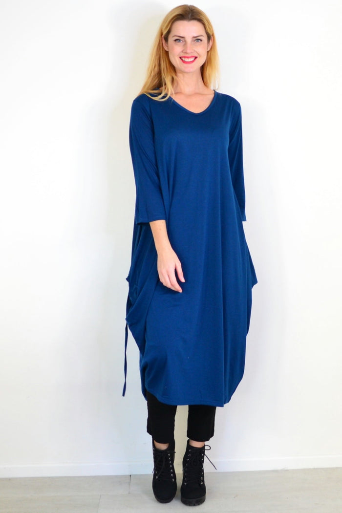 Lilia Whispers teal oversized tunic dress with relaxed fit, long sleeves, and casual style, displayed on a hanger.