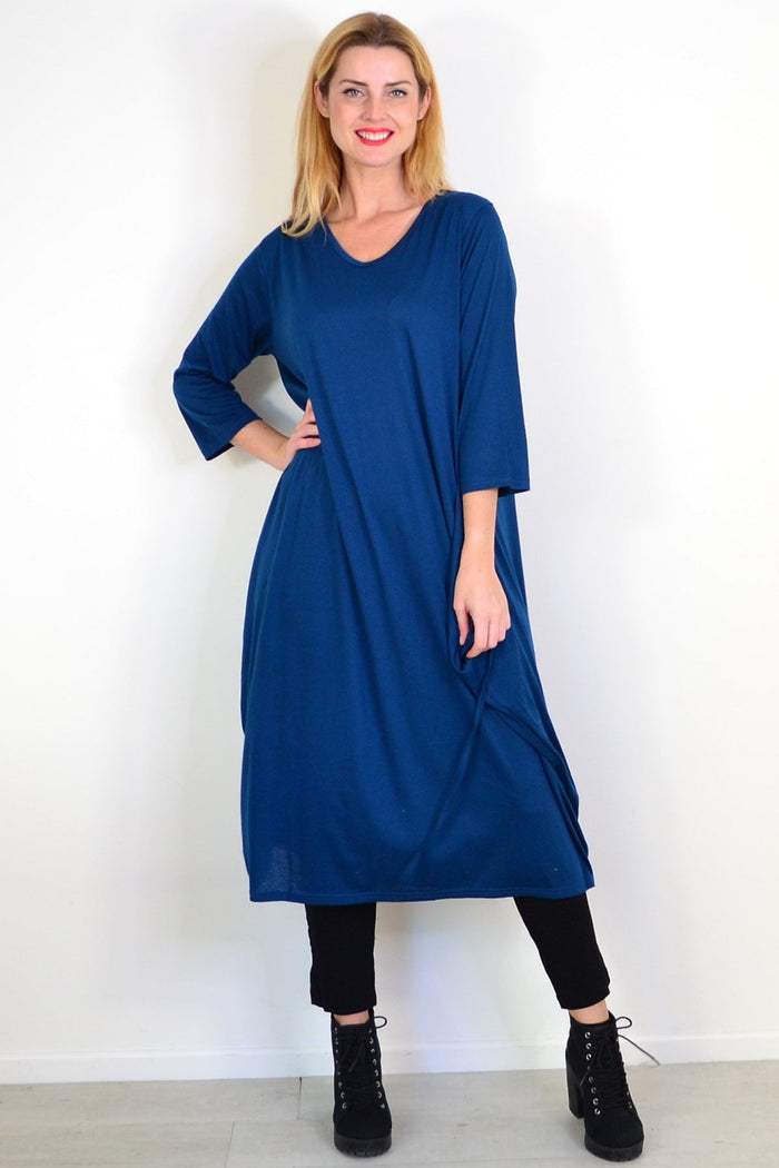 Lilia Whispers teal relaxed oversized tunic dress displayed on a hanger with a casual, flowy fit and long sleeves.