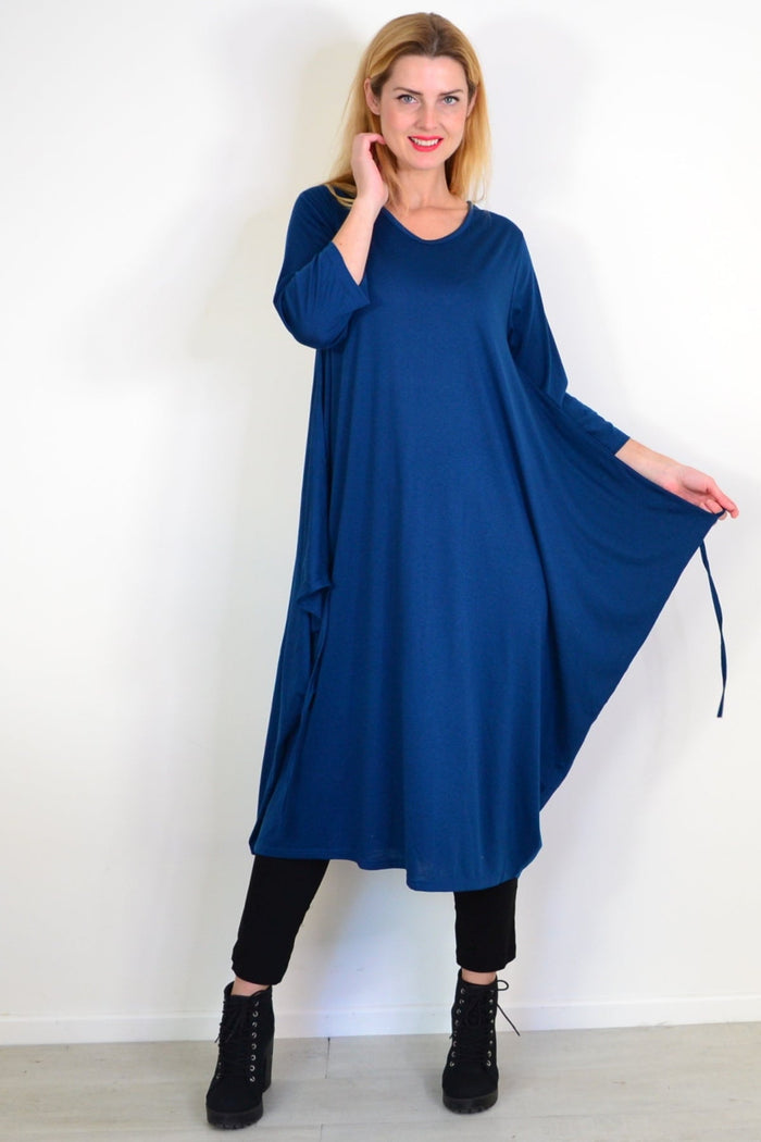 Lilia Whispers teal relaxed oversized tunic dress, flowing fabric, long sleeves, casual fit, displayed on a hanger.